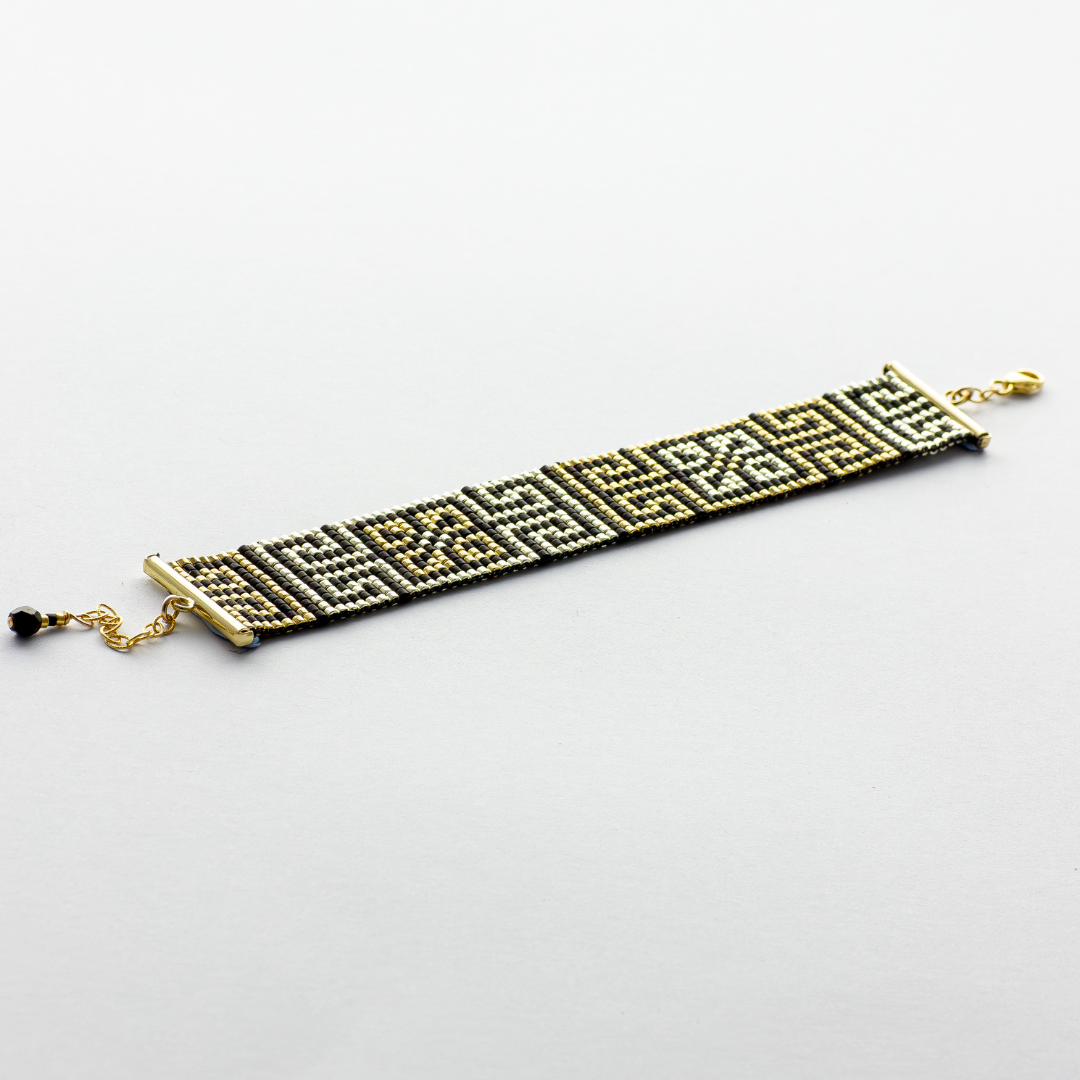 Road to Egypt bracelet showcasing a Tatreez pattern from Yafa and Ramallah in Black and gold and silver.