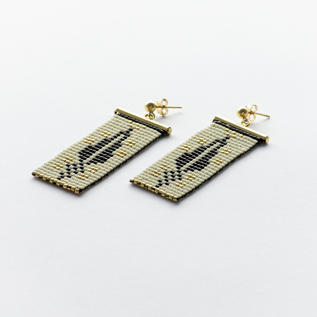 Close-up of Cypress Earrings in dark cream - Highlighting black and gold beads