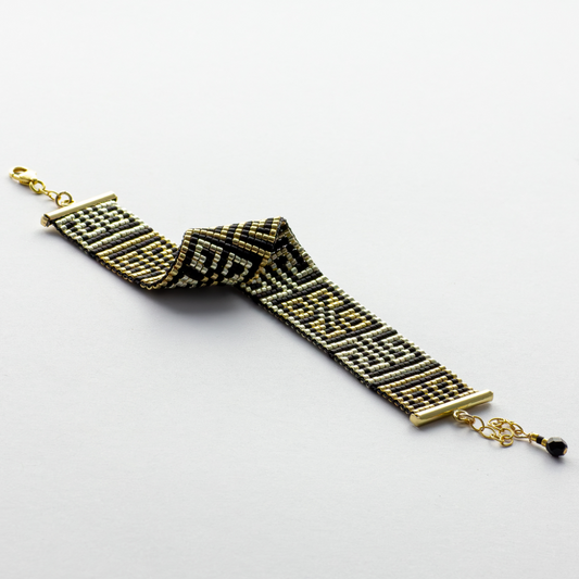 Road to Egypt bracelet showcasing a Tatreez pattern from Yafa and Ramallah in Black and gold and silver.