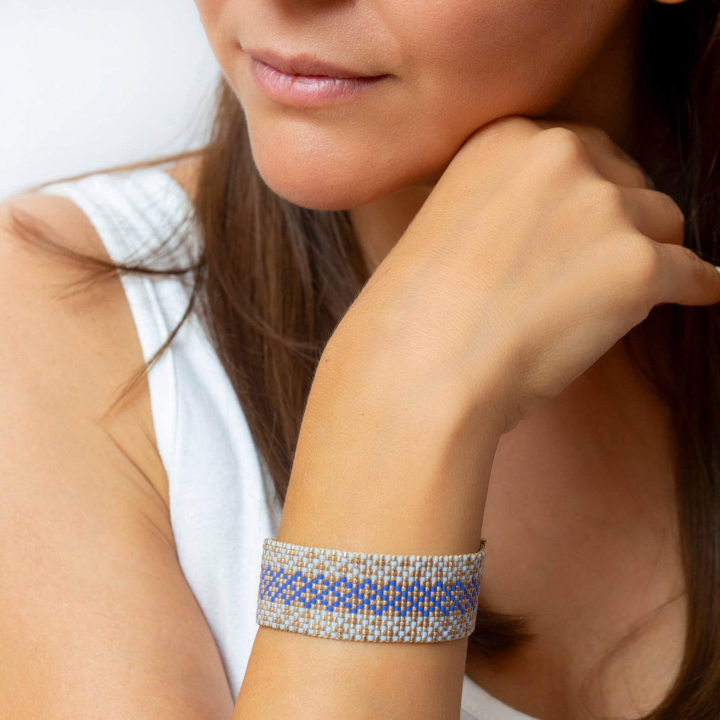 Syrian Inhabited Scroll bracelet showcasing a Tatreez pattern from Palestine in Blue and Gold