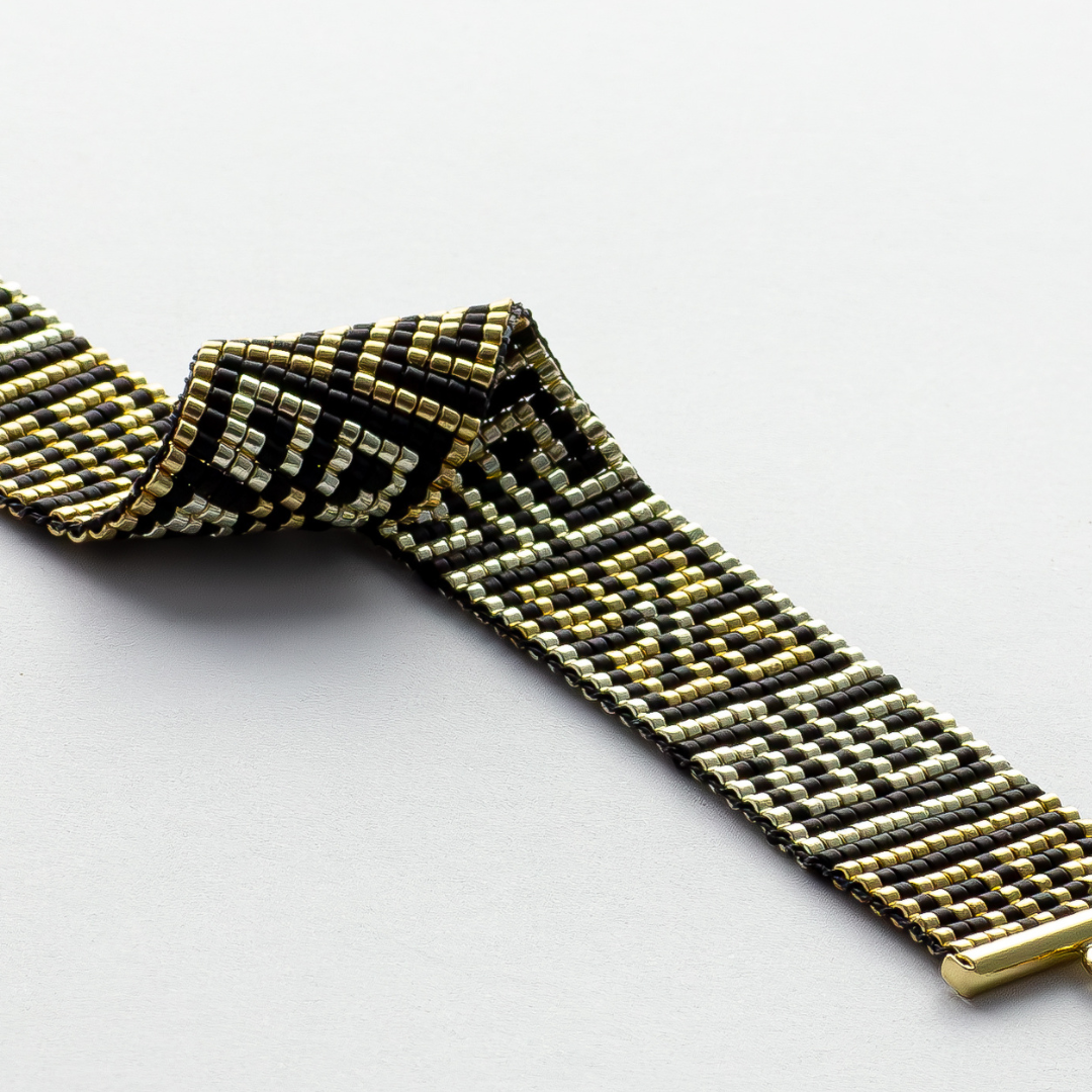 Road to Egypt bracelet showcasing a Tatreez pattern from Yafa and Ramallah in Black and gold and silver.