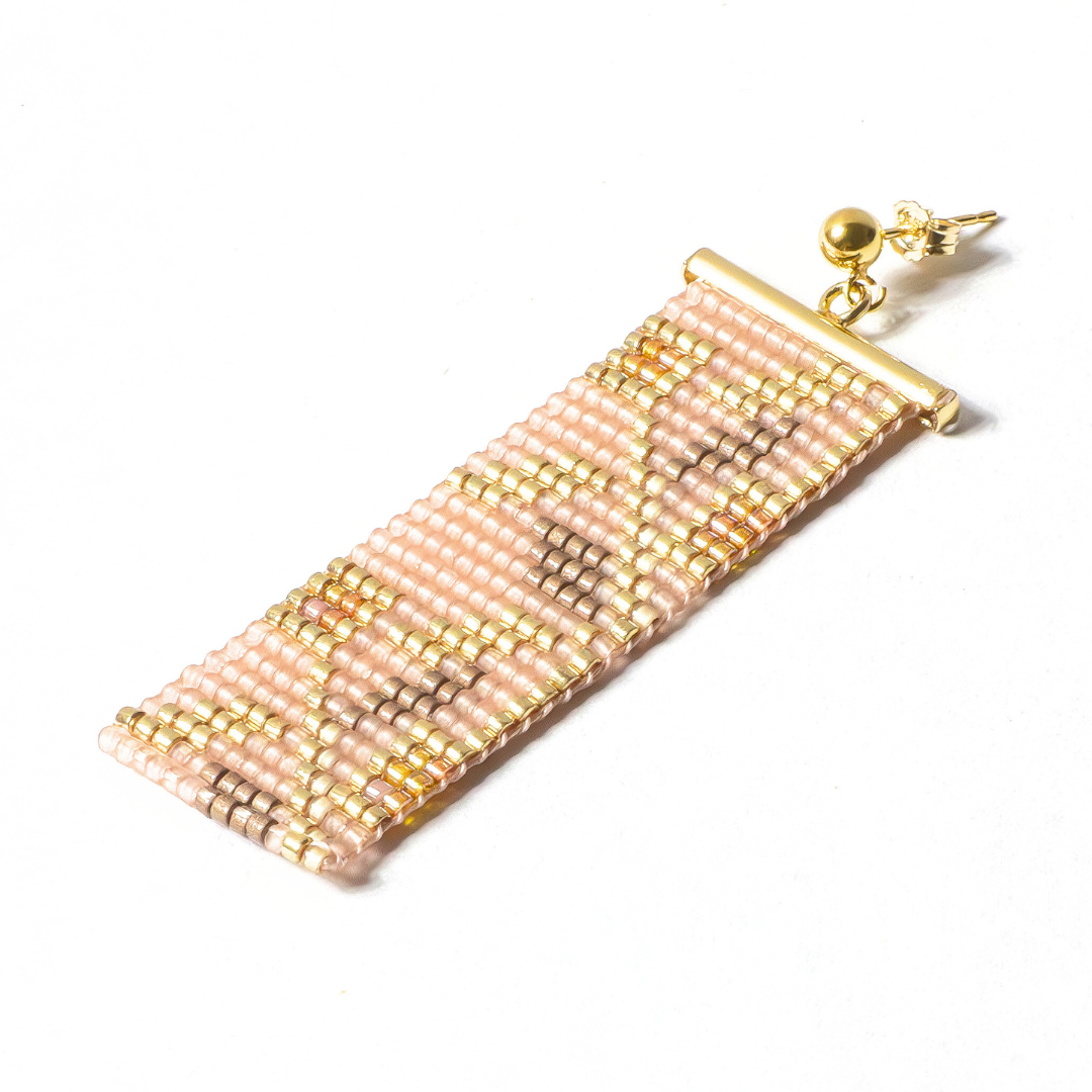 single handwoven earring on a white background
