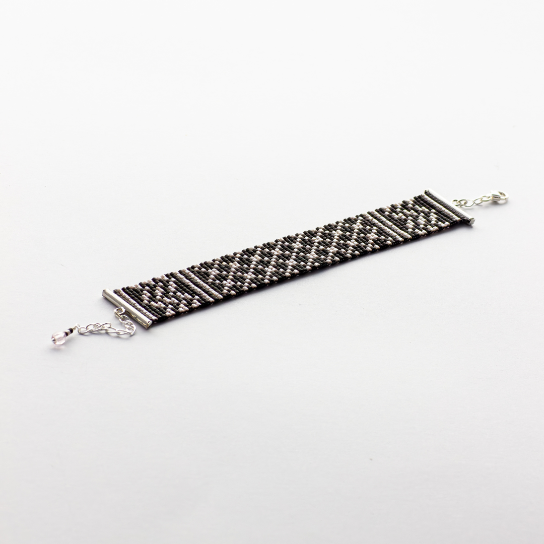 Black Kuffiyeh bracelet showcasing a Kuffiyeh in black and champagne beads