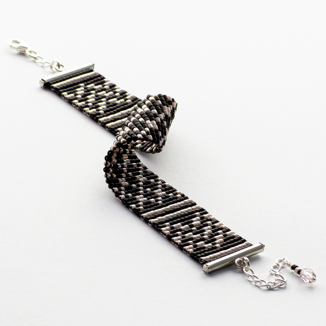 Black Kuffiyeh bracelet showcasing a Kuffiyeh in black and champagne beads