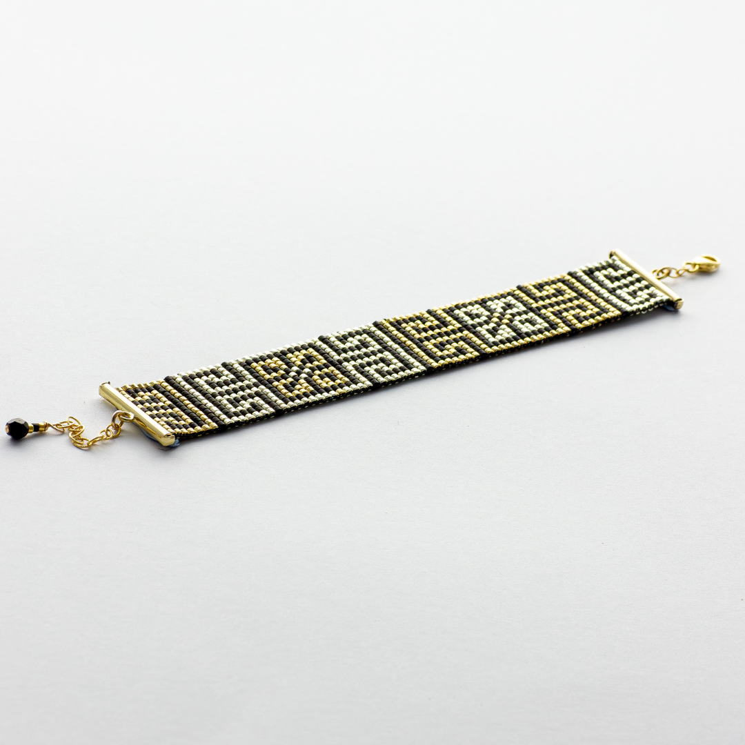 Road to Egypt bracelet showcasing a Tatreez pattern from Yafa and Ramallah in Black and gold and silver. 