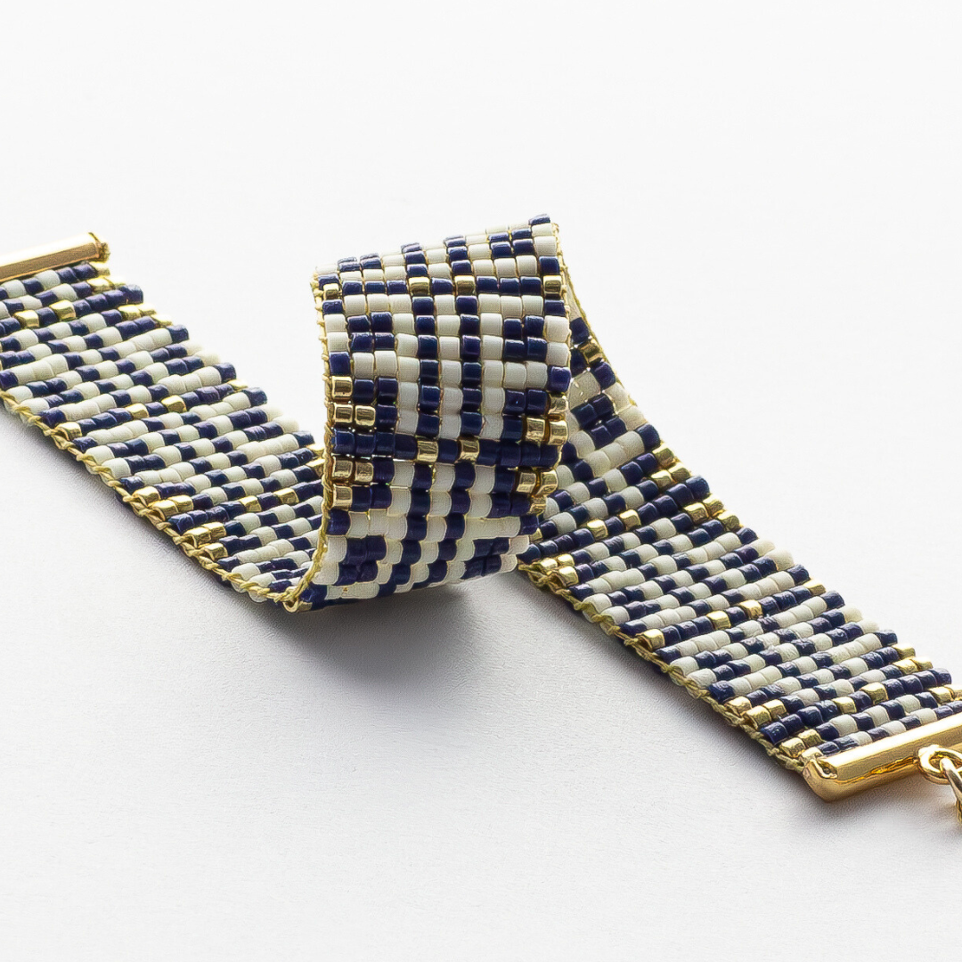 Chainmail bracelet showcasing a Tatreez pattern from Esdud in Navy Blue, Cream and Gold