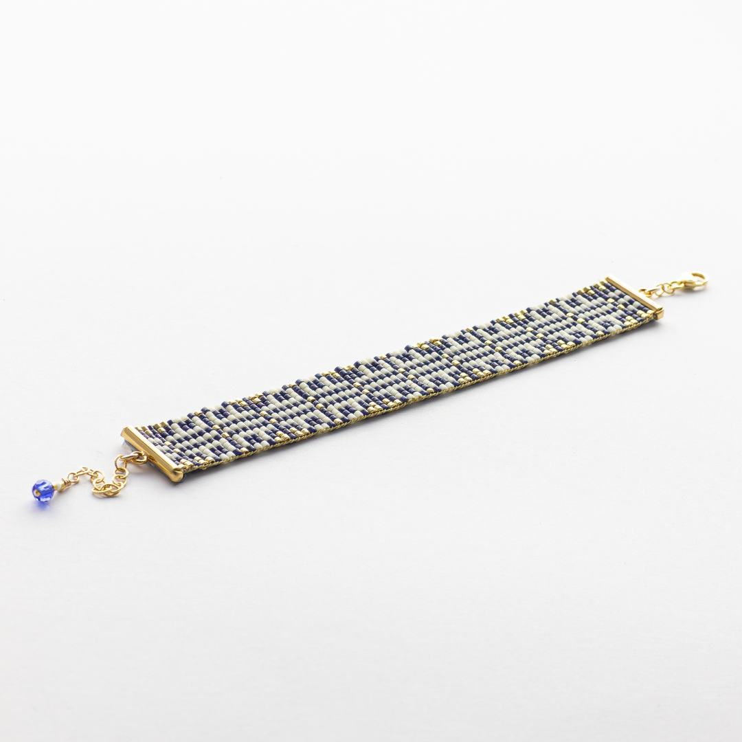 Chainmail bracelet showcasing a Tatreez pattern from Esdud in Navy Blue, Cream and Gold