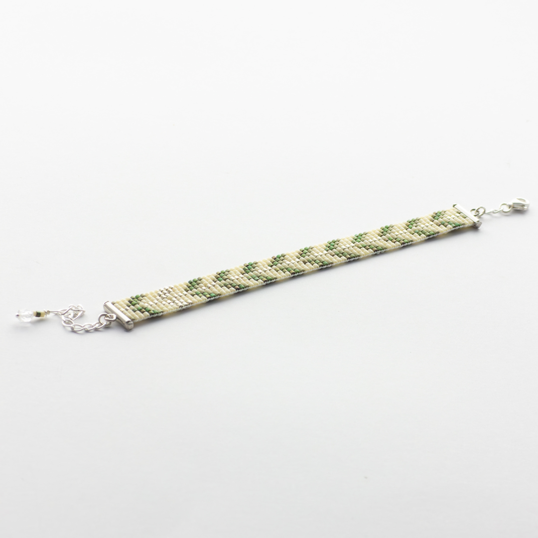 Trees bracelet showcasing a Tatreez pattern from Esdud in Olive Green and Silver