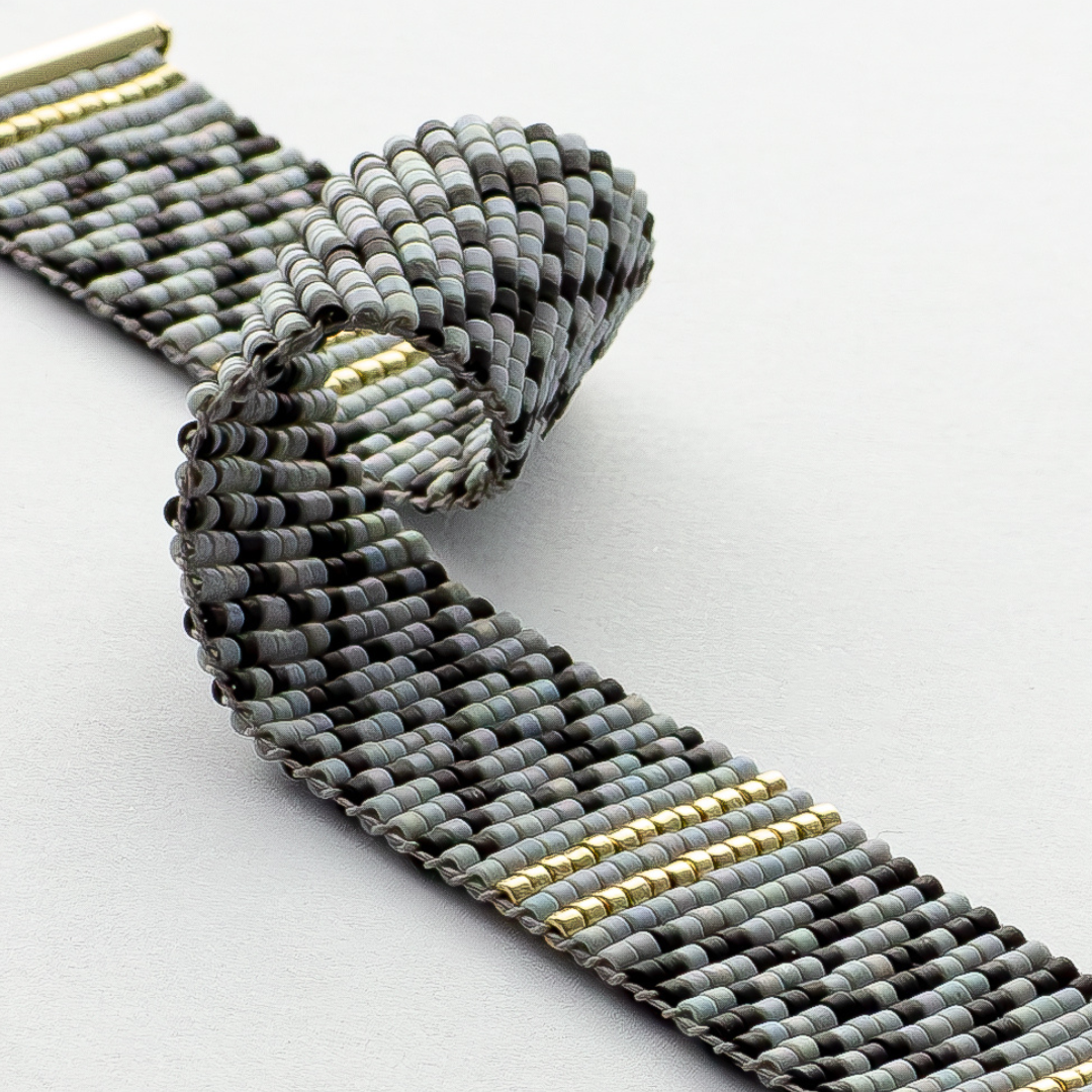 Gray Kuffiyeh bracelet showcasing a kufieyh keffiyeh pattern in gray black and gold