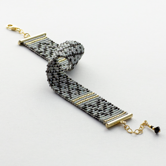 Gray Kuffiyeh bracelet showcasing a kufieyh keffiyeh pattern in gray black and gold