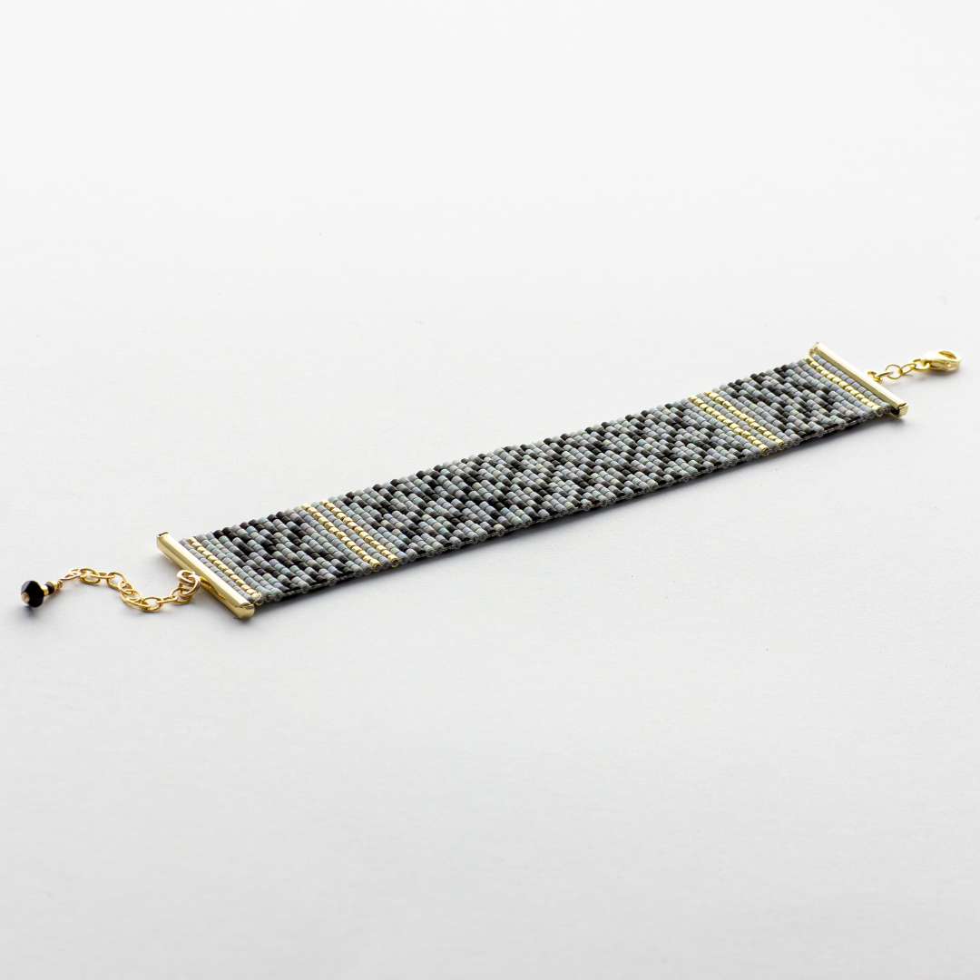 Gray Kuffiyeh bracelet showcasing a kufieyh keffiyeh pattern in gray black and gold