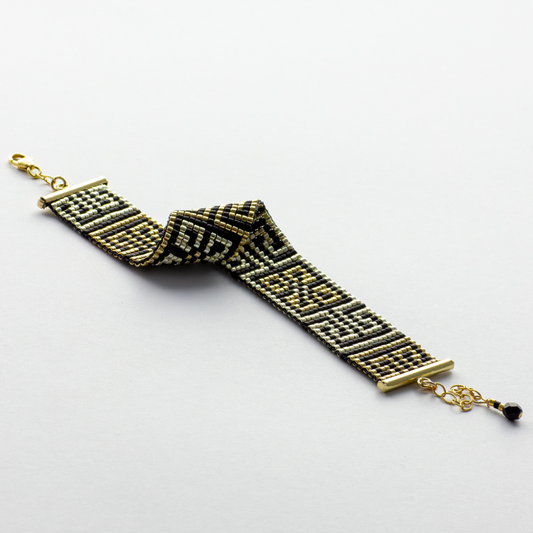 Road to Egypt bracelet showcasing a Tatreez pattern from Yafa and Ramallah in Black and gold and silver. 