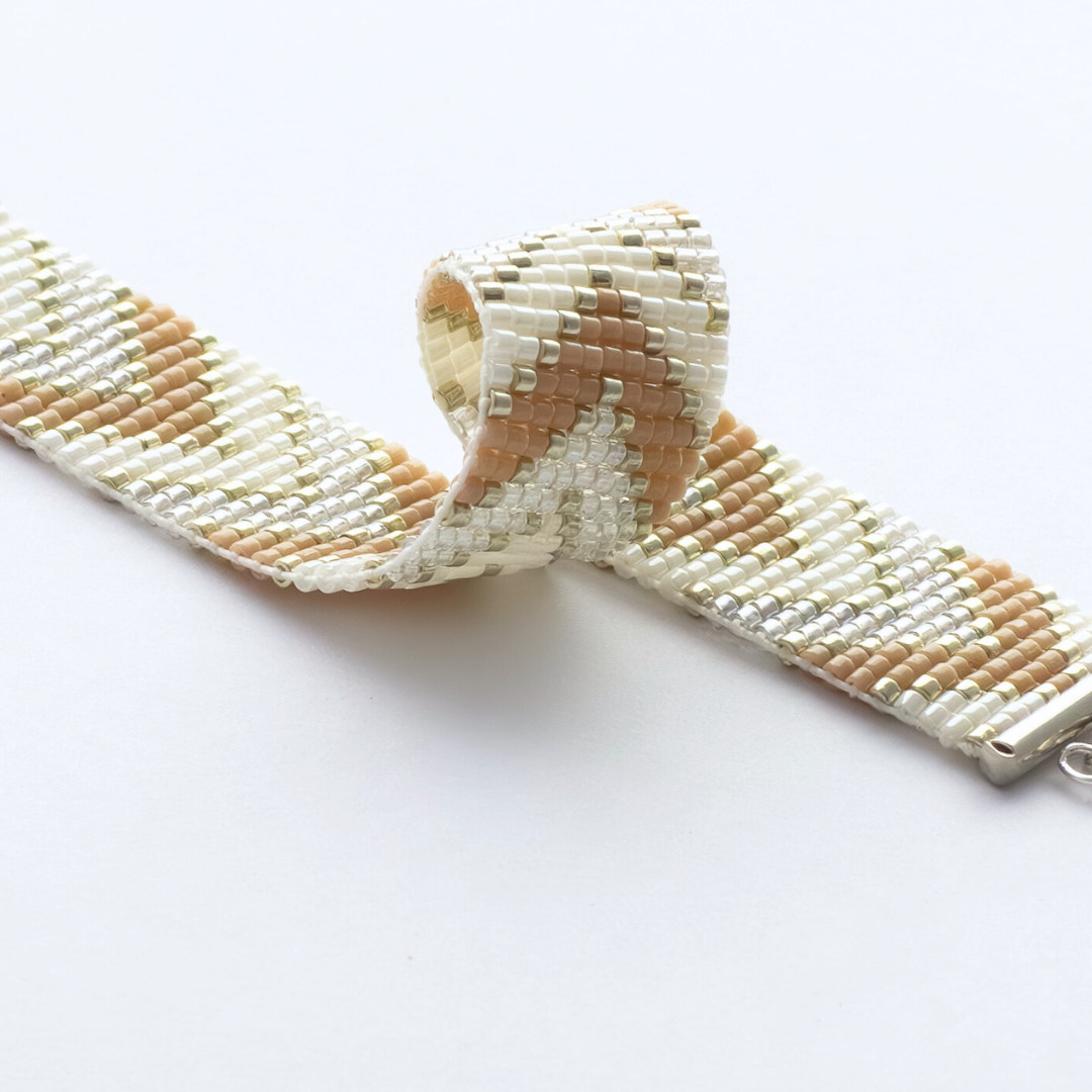 Sickles in Beige bracelet showcasing a Tatreez pattern from Ramallah in Beige, cream and shiny silver