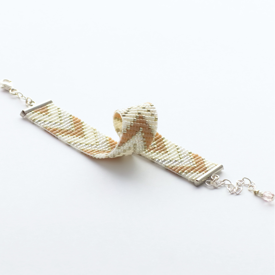 Sickles in Beige bracelet showcasing a Tatreez pattern from Ramallah in Beige, cream and shiny silver