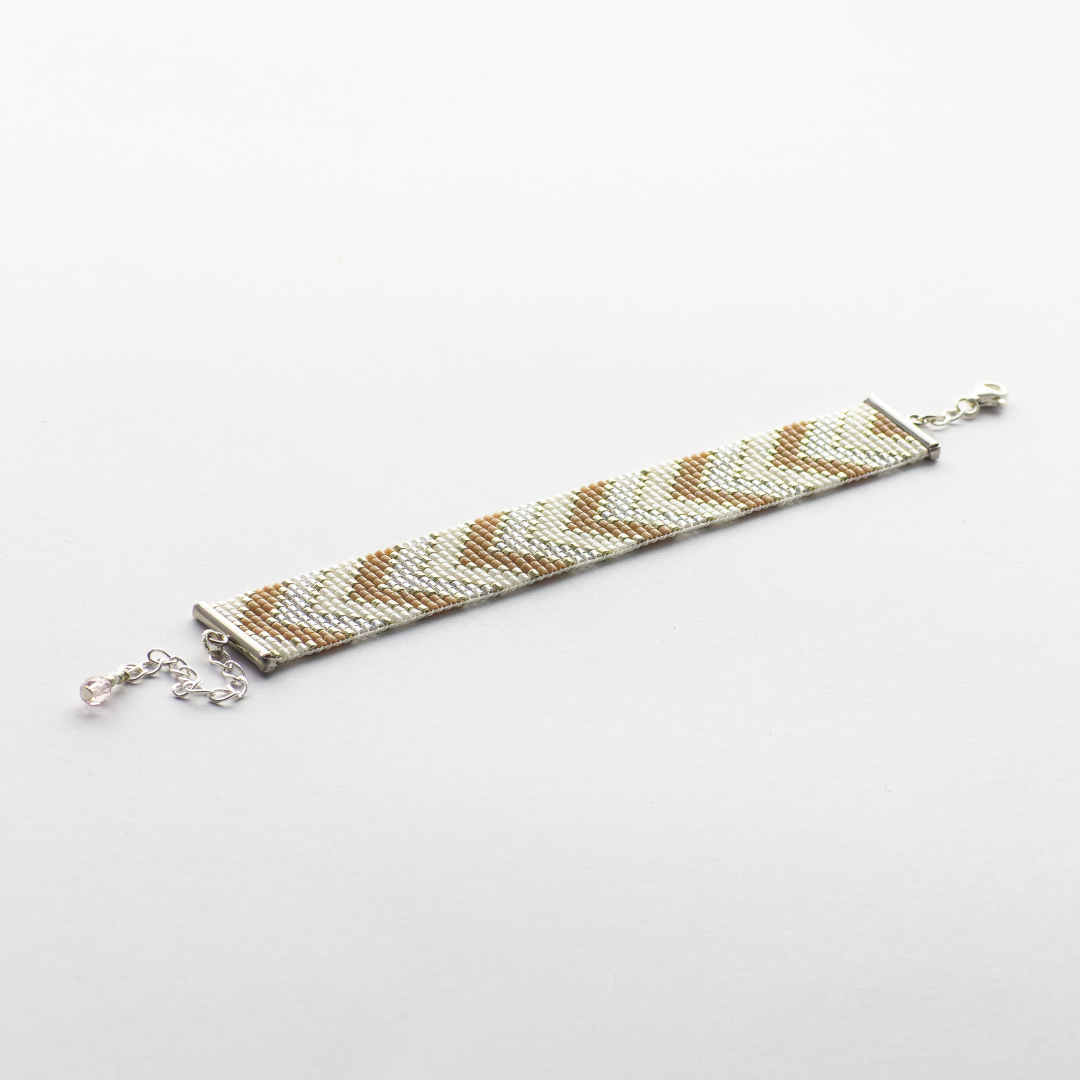 Sickles in Beige bracelet showcasing a Tatreez pattern from Ramallah in Beige, cream and shiny silver