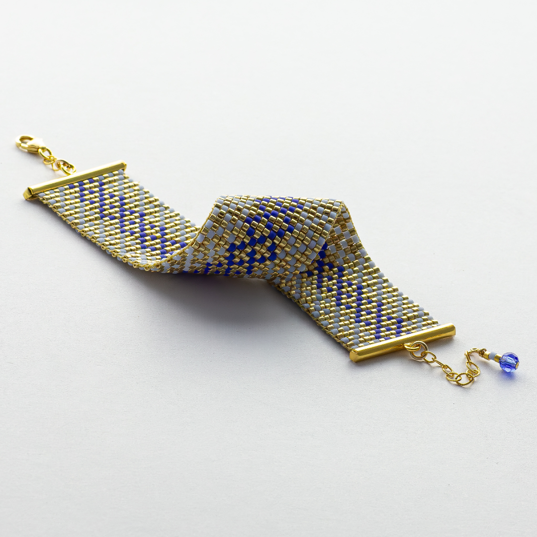 Syrian Inhabited Scroll bracelet showcasing a Tatreez pattern from Palestine in Blue and Gold 