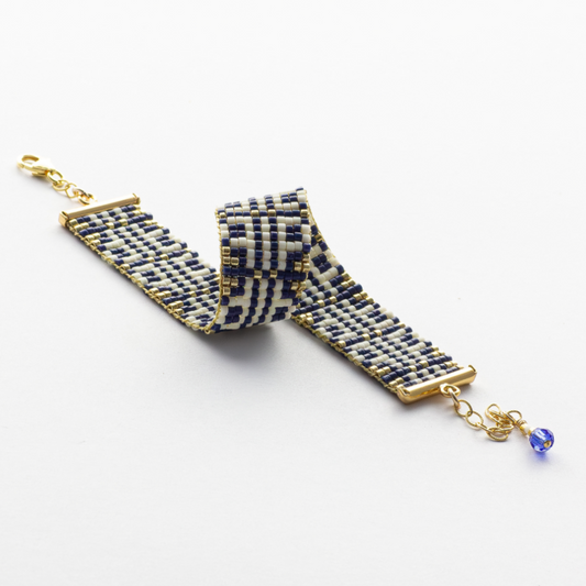 Chainmail bracelet showcasing a Tatreez pattern from Esdud in Navy Blue, Cream and Gold