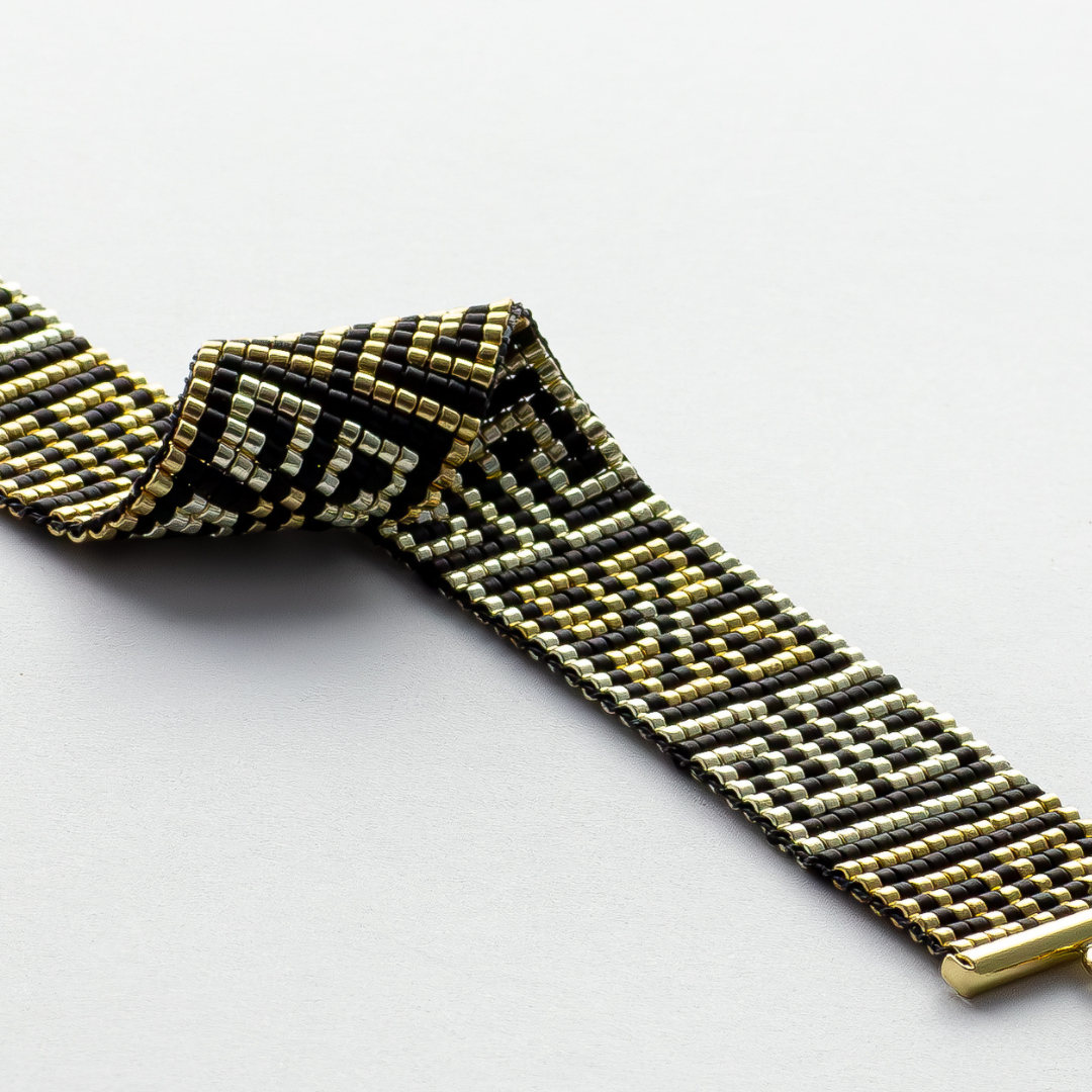 Road to Egypt bracelet showcasing a Tatreez pattern from Yafa and Ramallah in Black and gold and silver. 