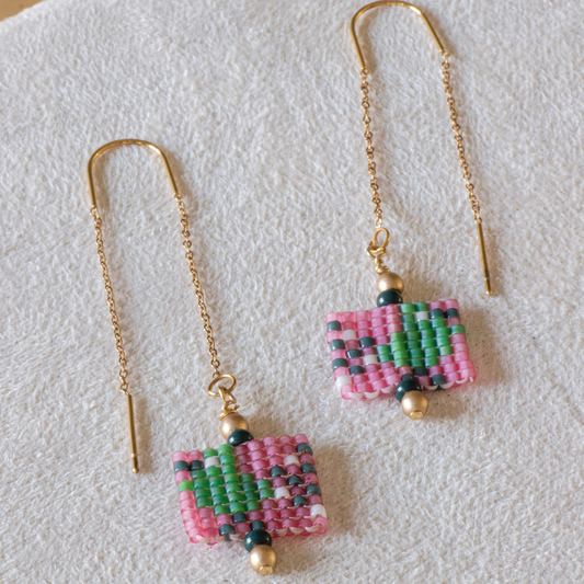 Hand-beaded Tatreez threader earrings in evergreen, pale turquoise, rose and papaya orange on white background. Asafir bird motif in Miyuki Delica beads on 304L stainless steel.

