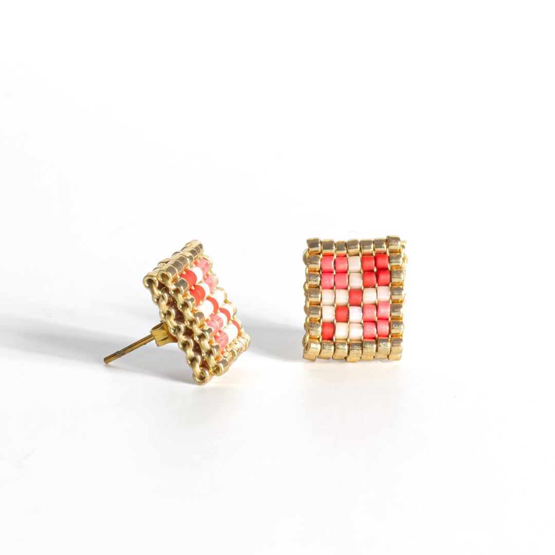 Double-faced Tatreez stud earrings in brick red, pink champagne, gold and cranberry on white background. Front view. Hypoallergenic gold stainless steel post.
