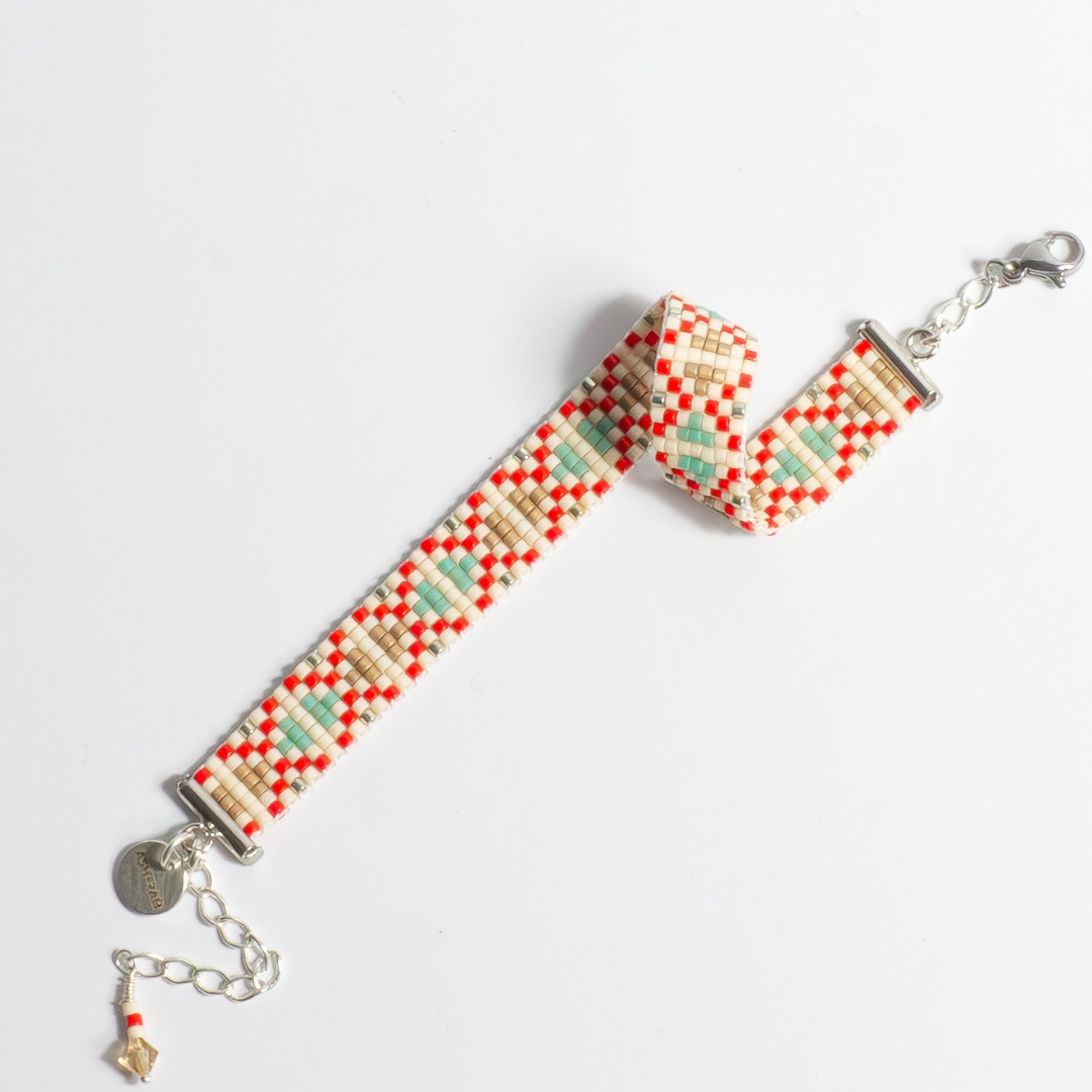 Hand-beaded Tatreez woven bracelet in true red, silver, antique beige, sea foam and champagne on white background. Full view. Available with adjustable stainless steel clasp or sterling silver lobster clasp.